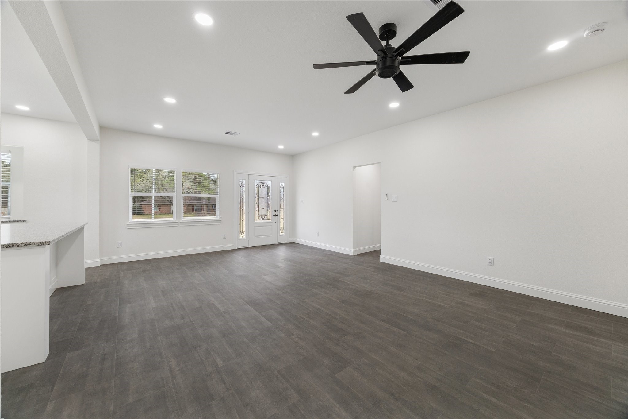 30731 Martens Road Tomball, TX 77375 - Photo 13 of 25 an empty room with windows and fan