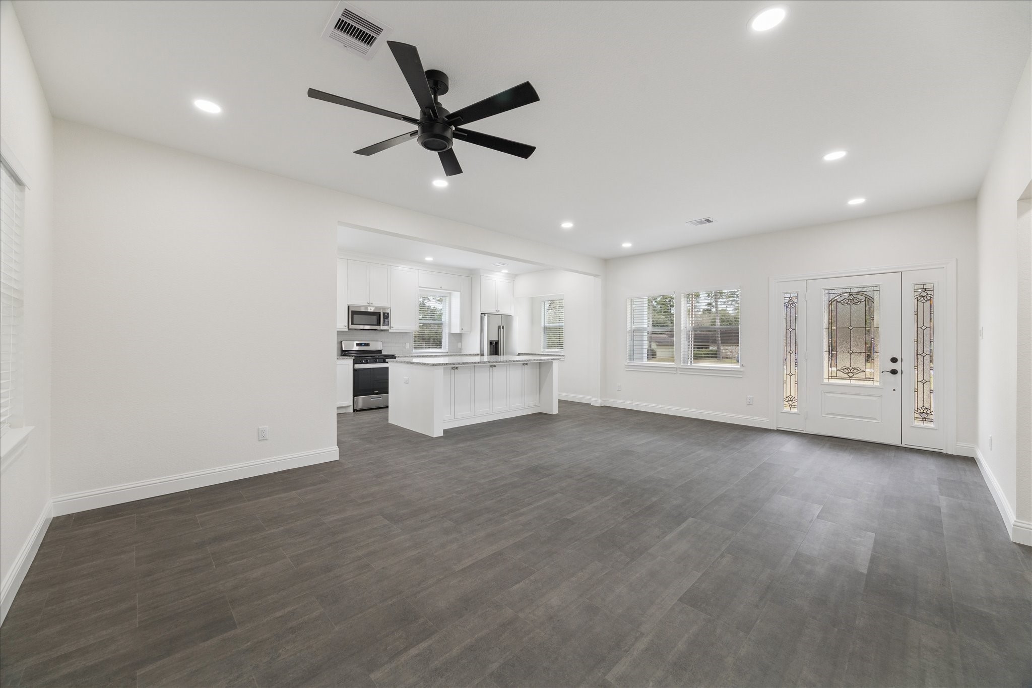 30731 Martens Road Tomball, TX 77375 - Photo 14 of 25 a view of a kitchen with wooden floor and window