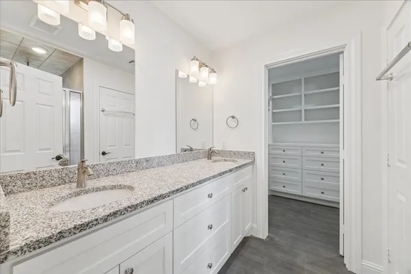 a view of walk in closet with empty racks