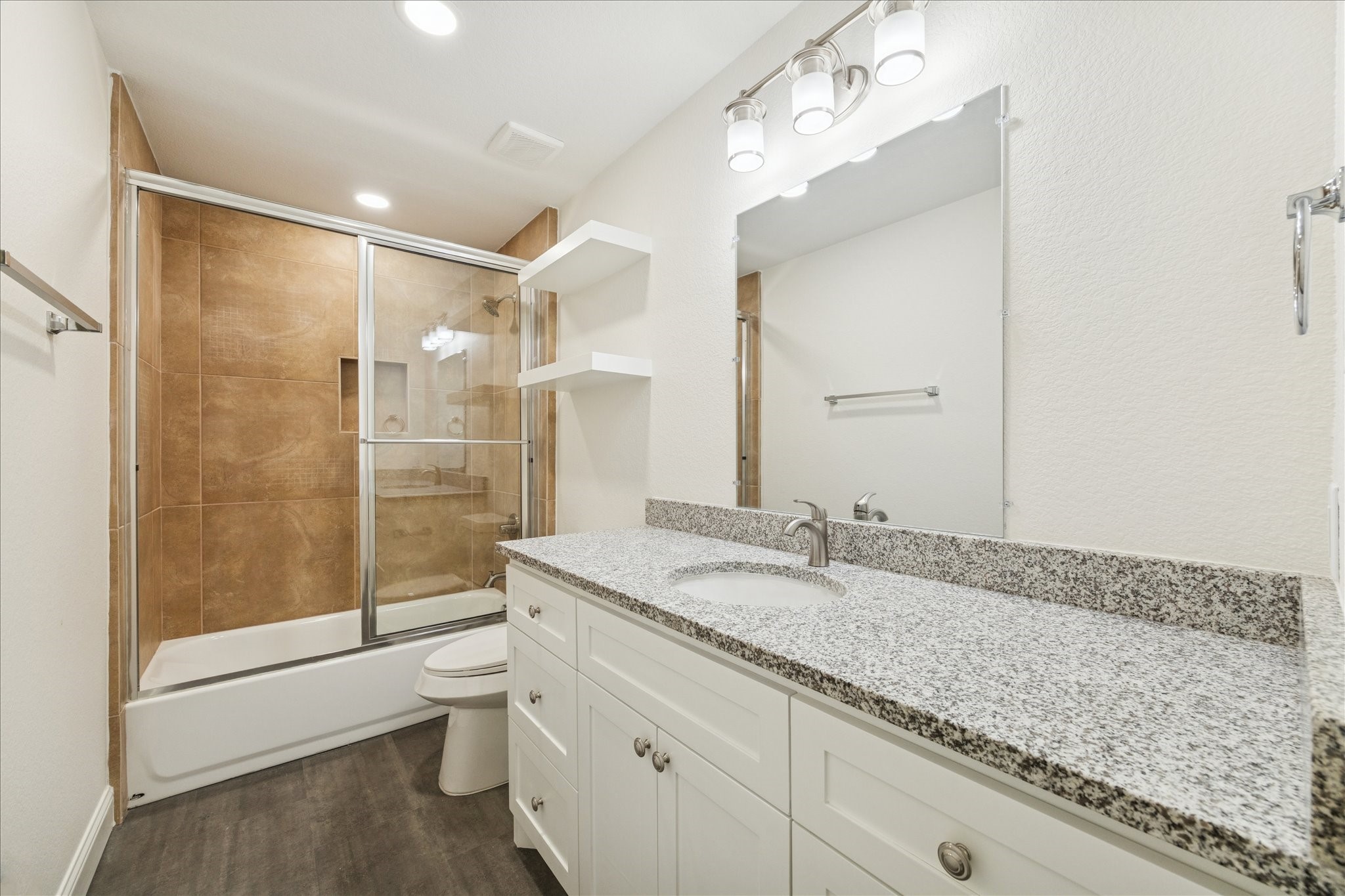 30731 Martens Road Tomball, TX 77375 - Photo 19 of 25 a bathroom with a granite countertop sink a toilet a mirror and shower