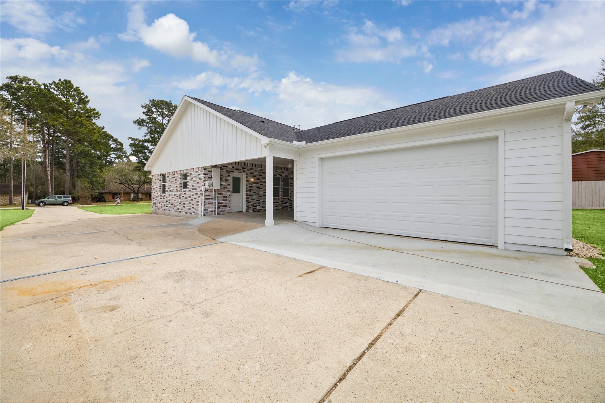 30731 Martens Road Tomball, TX 77375 - Photo 23 of 25 a front view of a house with a yard and garage
