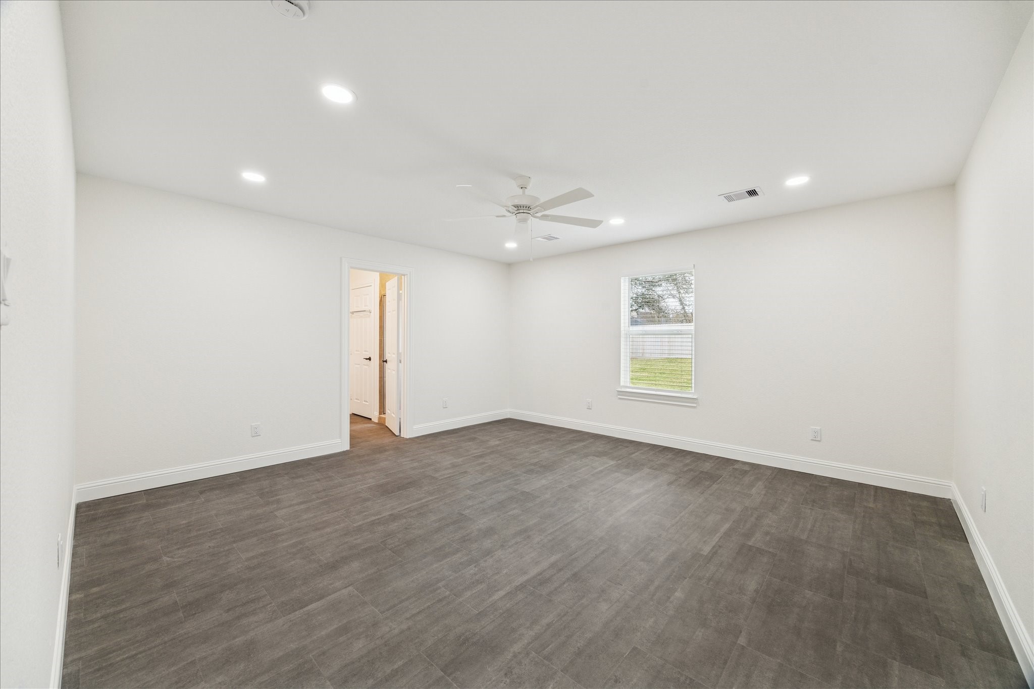 30731 Martens Road Tomball, TX 77375 - Photo 4 of 25 an empty room with windows and ceiling fan