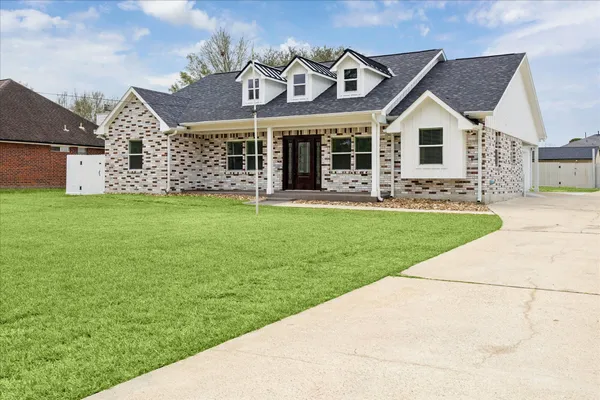 a view of kitchen with kitchen island a sink stainless steel appliances and cabinets