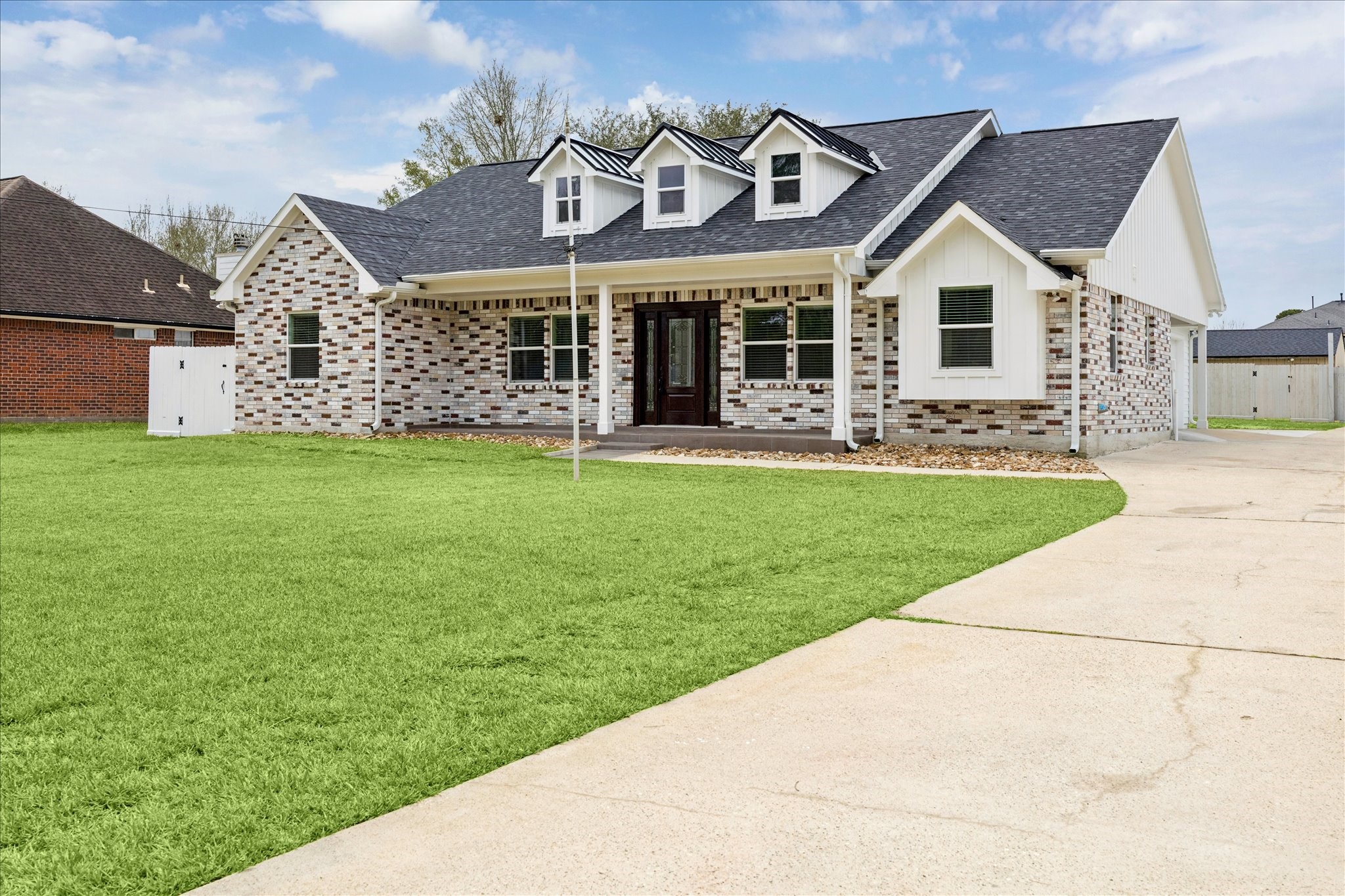 30731 Martens Road Tomball, TX 77375 - Photo 7 of 25 a front view of a house with a garden and yard