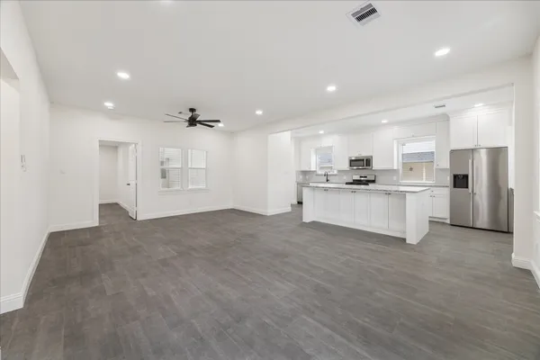 a kitchen with white cabinets and stainless steel appliances
