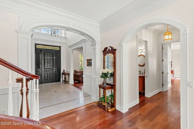 a view of an entryway with wooden floor and a livingroom