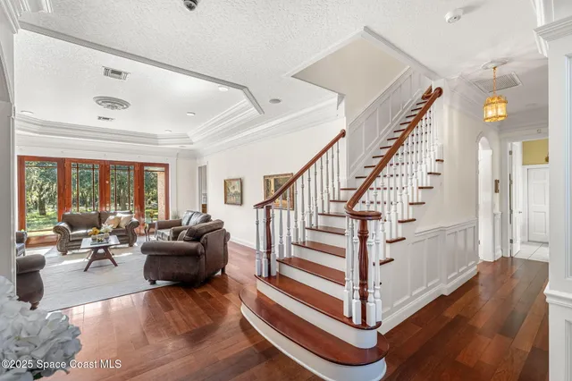 a view of entryway and hall with wooden floor