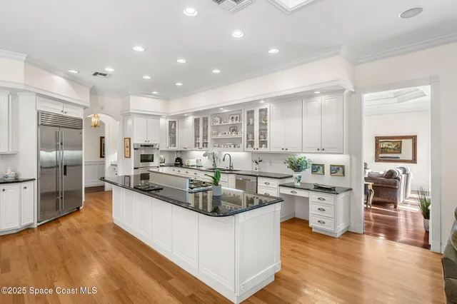 a large kitchen with stainless steel appliances granite countertop a large counter top stainless steel appliances and cabinets