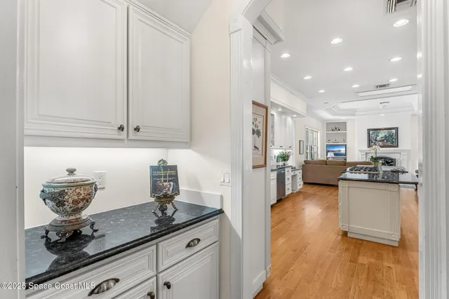 a kitchen with stainless steel appliances kitchen island granite countertop a refrigerator and a stove top oven