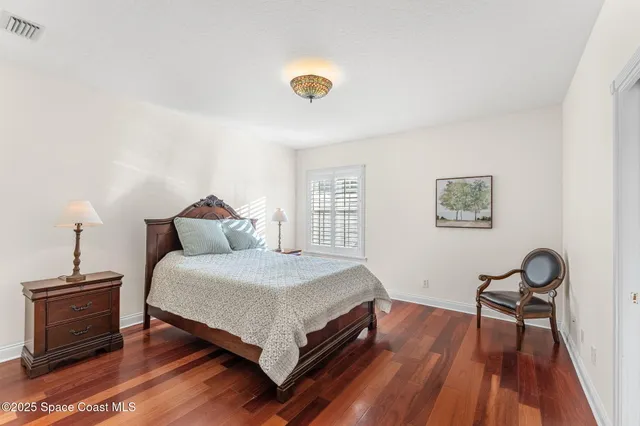 a view of a hallway with wooden floor and stairs