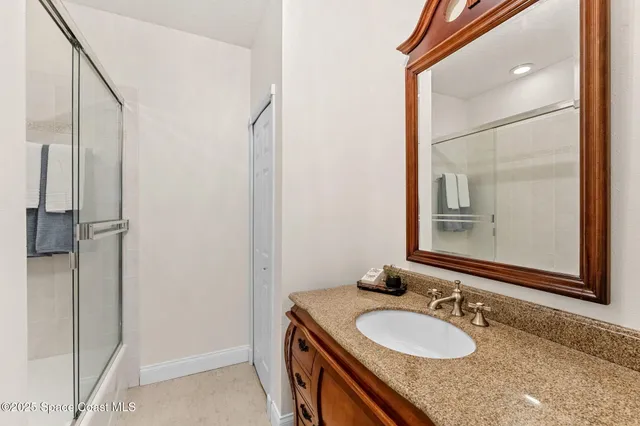 a spacious bedroom with a bed and wooden floor