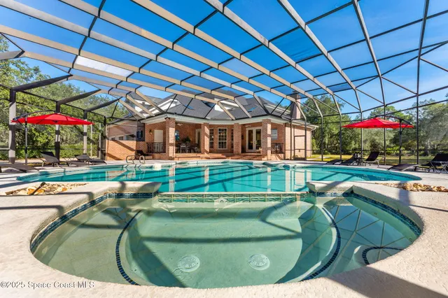 a view of a patio with a table and chairs
