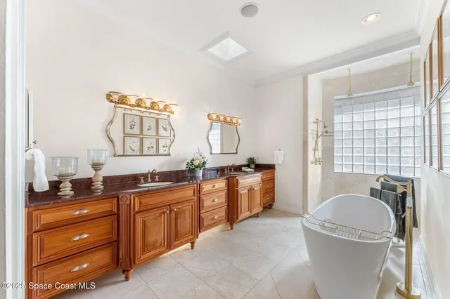 a spacious bathroom with a granite countertop sink and a mirror