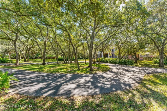 a view of a swimming pool with a house in the background