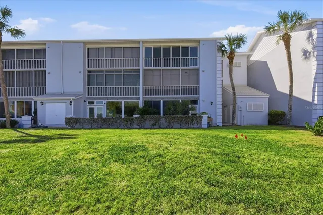 a view of a big building with big yard and large trees