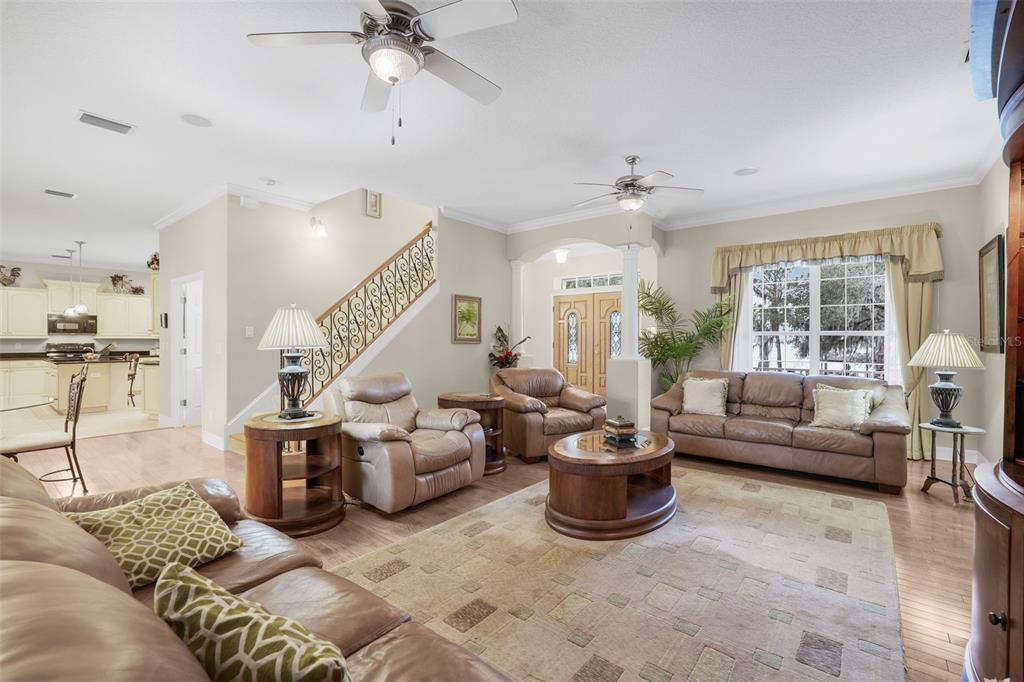 10336 Lake Louisa Road Clermont, FL 34711 - Photo 15 of 58 a living room with furniture and a chandelier
