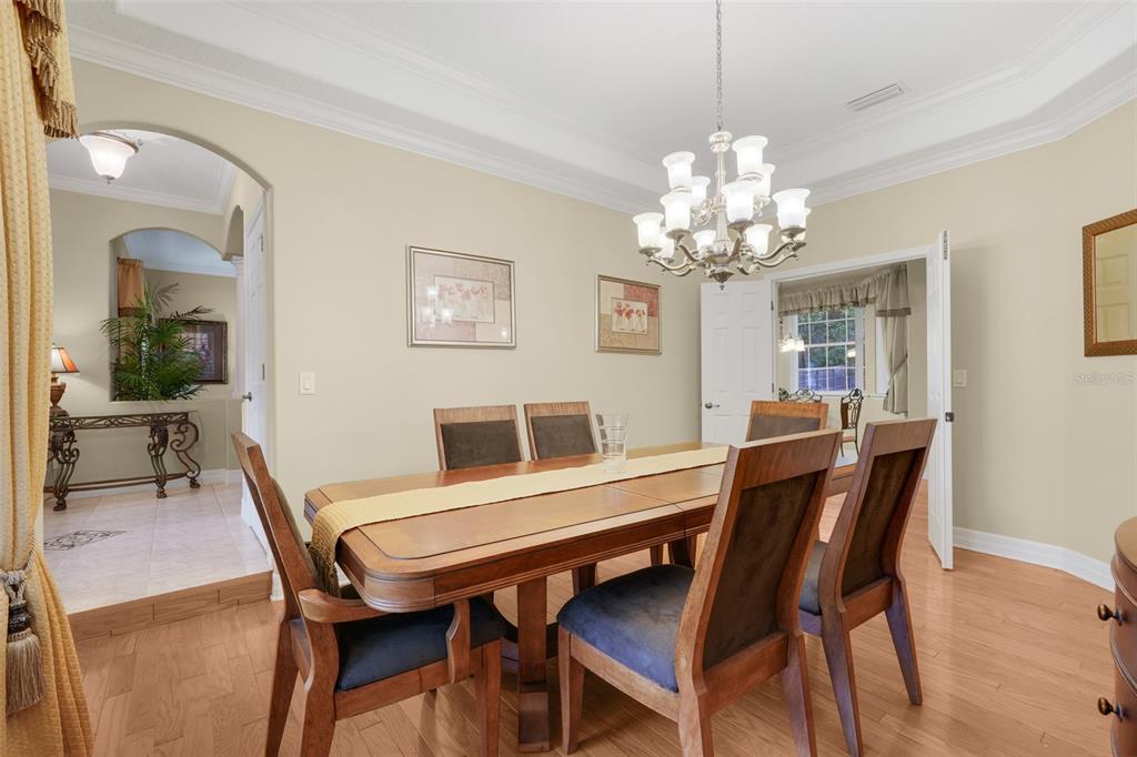 10336 Lake Louisa Road Clermont, FL 34711 - Photo 21 of 58 a view of a dining room with furniture and chandelier