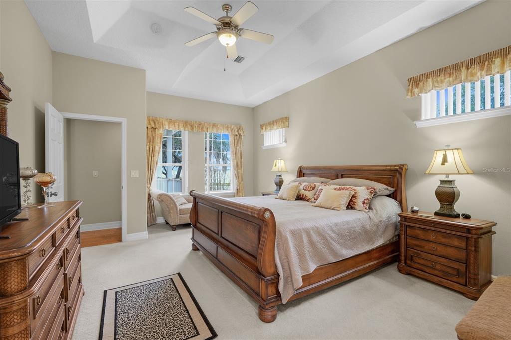 10336 Lake Louisa Road Clermont, FL 34711 - Photo 25 of 58 a bedroom with a bed and a chandelier