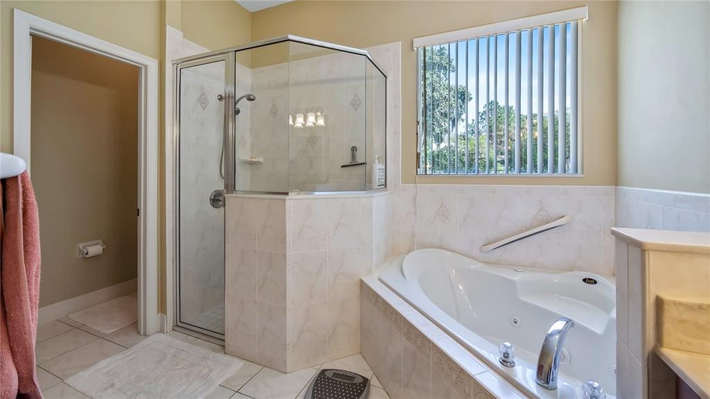 10336 Lake Louisa Road Clermont, FL 34711 - Photo 27 of 62 a bathroom with a tub and a shower