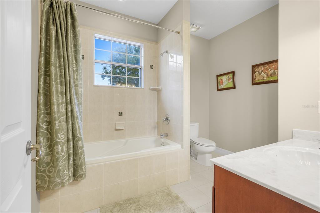 10336 Lake Louisa Road Clermont, FL 34711 - Photo 35 of 58 a bath room with a toilet and a bath tub