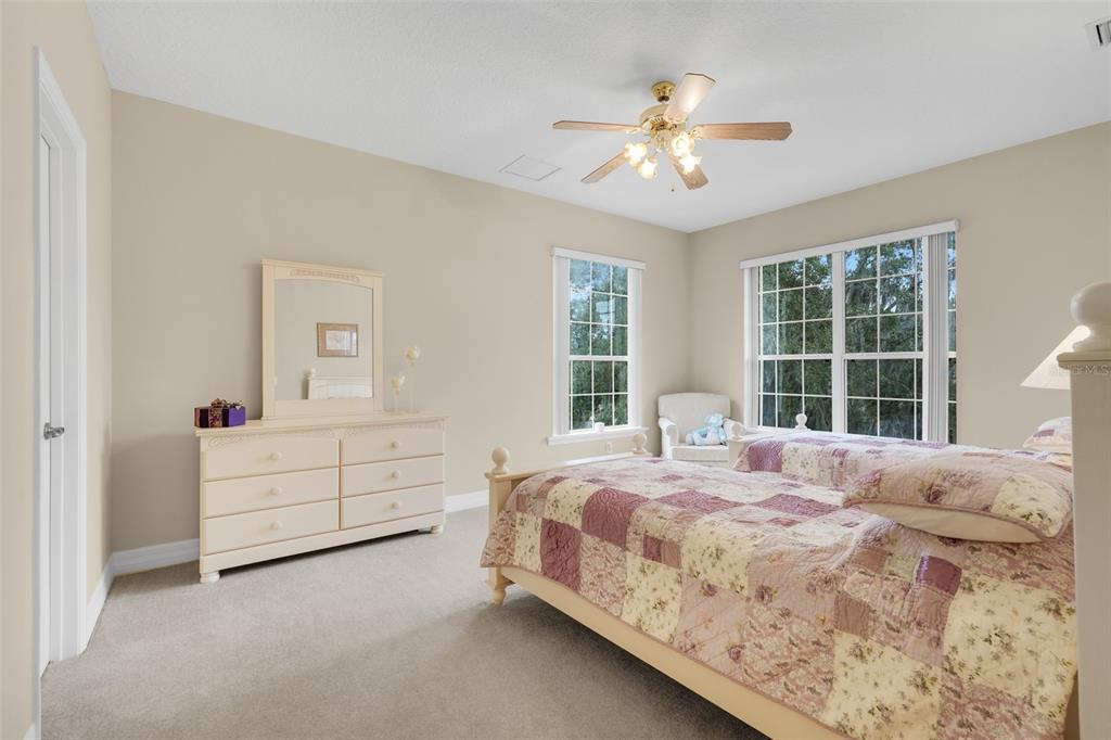 10336 Lake Louisa Road Clermont, FL 34711 - Photo 38 of 58 a bedroom with a large bed and a window