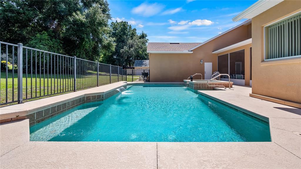 10336 Lake Louisa Road Clermont, FL 34711 - Photo 45 of 62 a view of backyard with swimming pool and outdoor seating