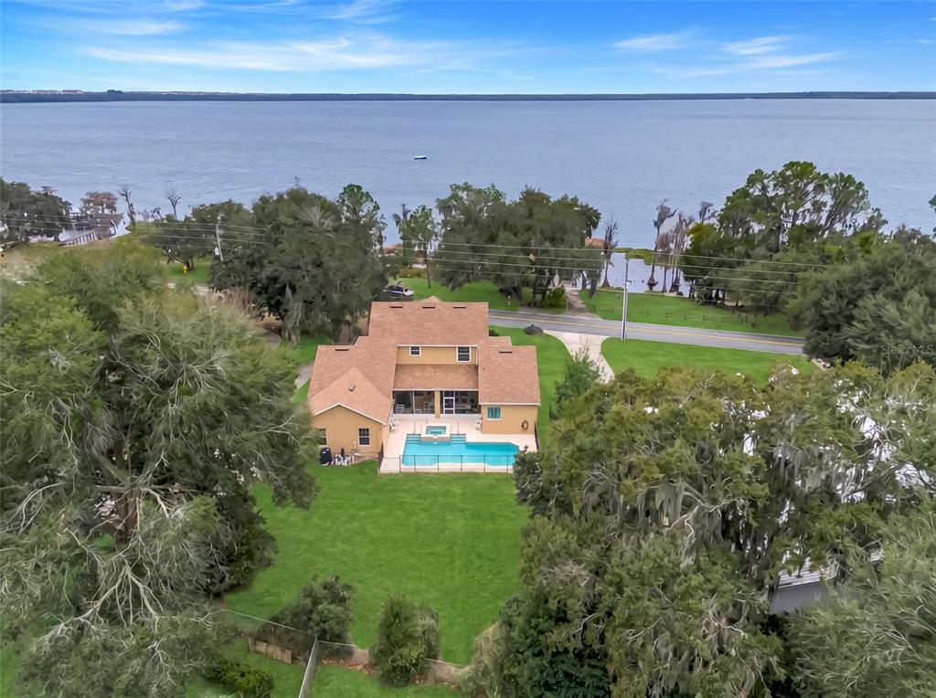 10336 Lake Louisa Road Clermont, FL 34711 - Photo 57 of 58 an aerial view of a house with a garden and trees in front of it