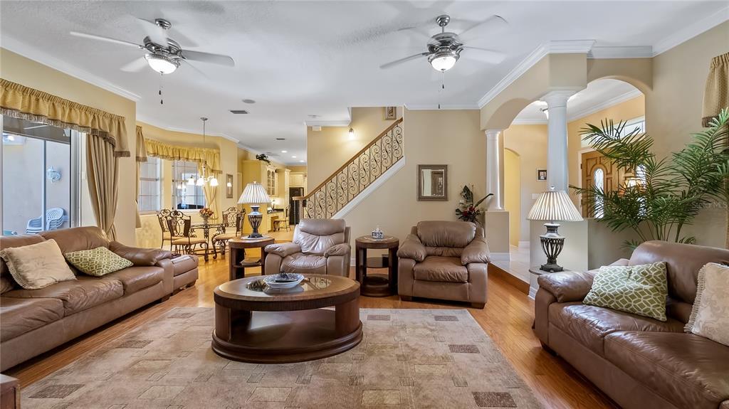 10336 Lake Louisa Road Clermont, FL 34711 - Photo 7 of 62 a living room with furniture and a chandelier