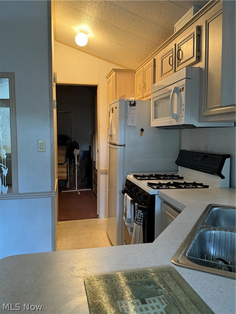 17875 Lashley Road, Unit 403 Senecaville, OH 43780 - Photo 12 of 22 Kitchen with sink, tile flooring, lofted ceiling, and stove