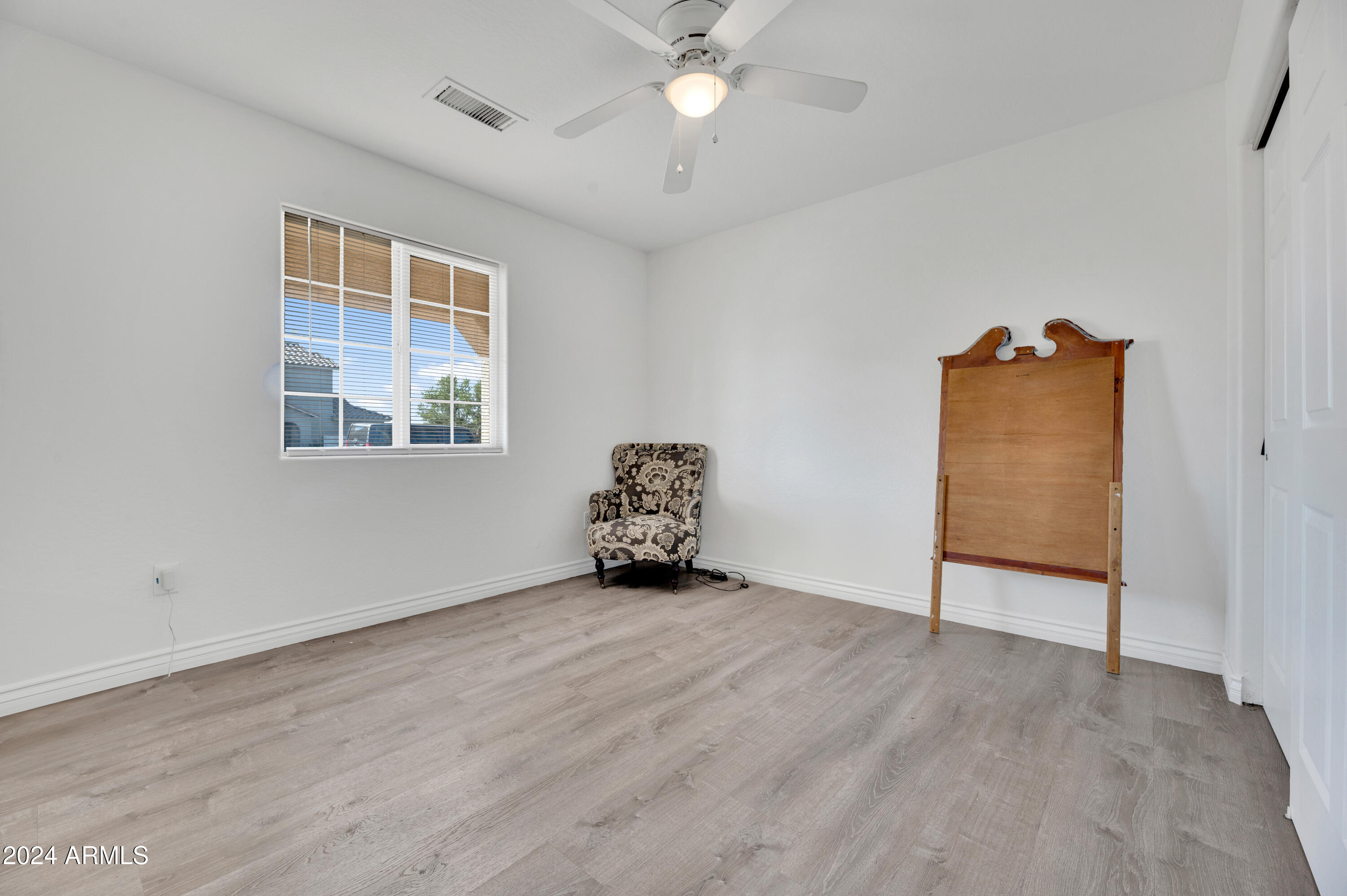 2702 East Juniper Avenue Phoenix, AZ 85032 - Photo 12 of 19 wooden floor in an empty room with a window
