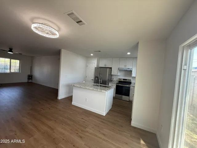 a kitchen with a sink and a stove top oven