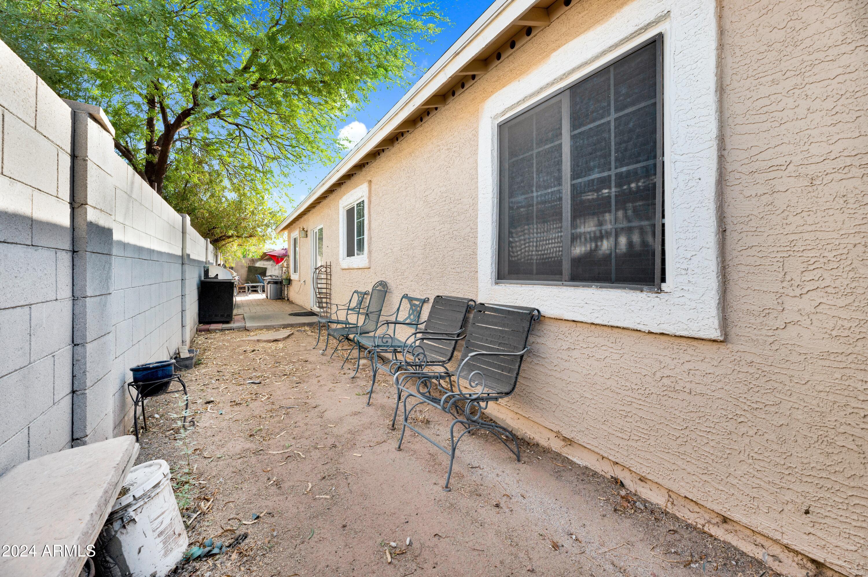 2702 East Juniper Avenue Phoenix, AZ 85032 - Photo 19 of 19 a backyard of a house with table and chairs