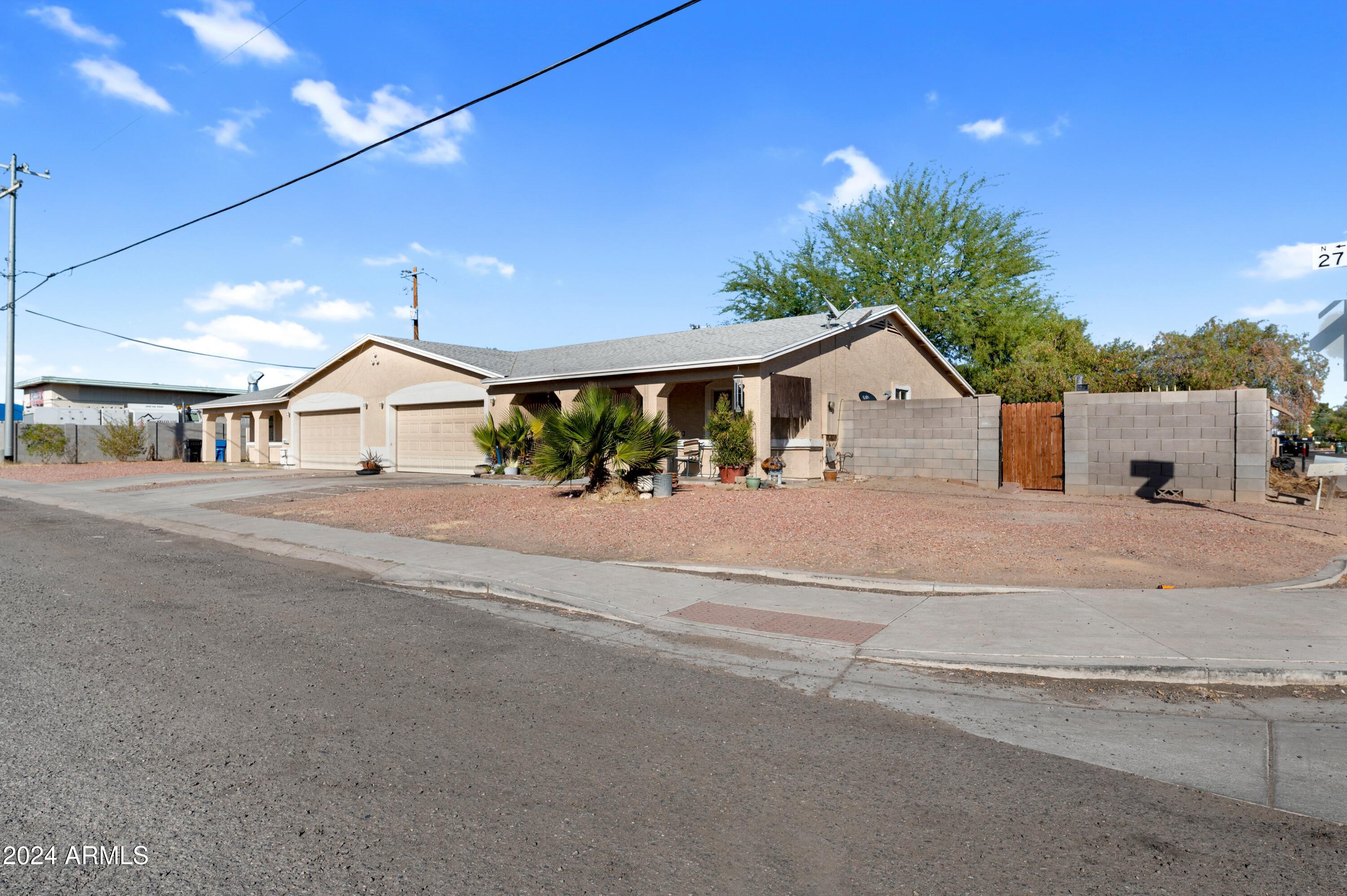 2702 East Juniper Avenue Phoenix, AZ 85032 - Photo 3 of 19 a view of a house with a street