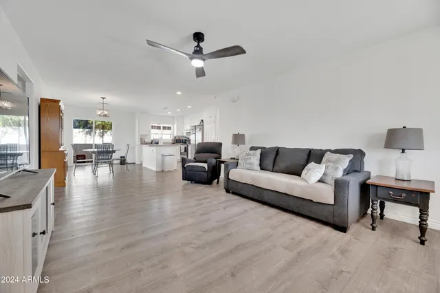 a living room with furniture and kitchen view