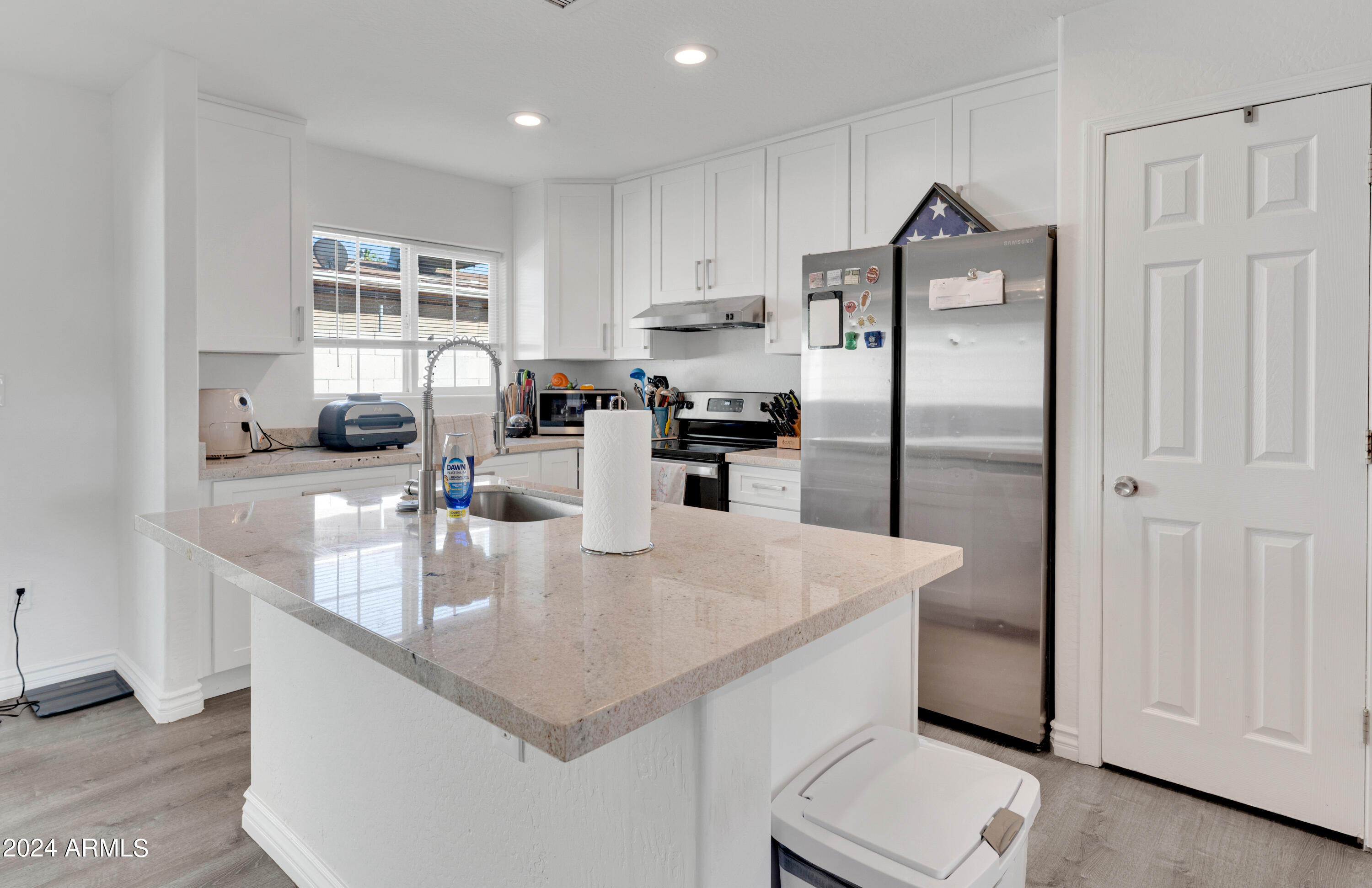 2702 East Juniper Avenue Phoenix, AZ 85032 - Photo 8 of 19 a kitchen with stainless steel appliances granite countertop a sink a refrigerator and a granite counter tops