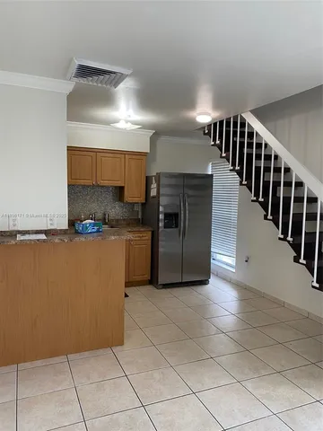 a kitchen with cabinets and stainless steel appliances