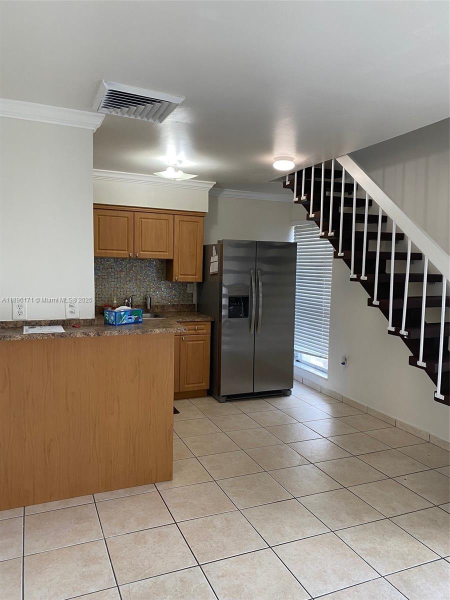 3901 Southwest 109th Avenue, Unit 9C Miami, FL 33165 - Photo 3 of 12 a kitchen with cabinets and stainless steel appliances