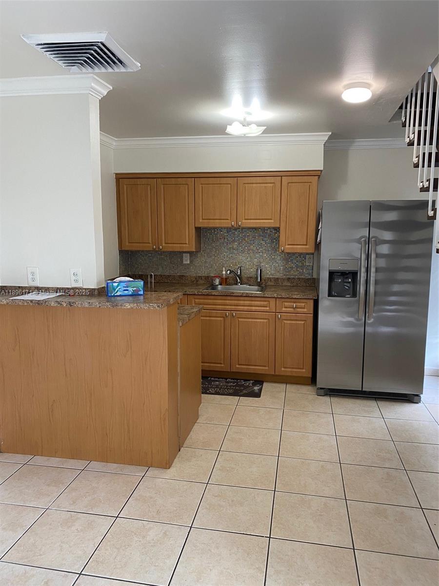 3901 Southwest 109th Avenue, Unit 9C Miami, FL 33165 - Photo 4 of 12 a kitchen with stainless steel appliances granite countertop a stove a sink and a microwave