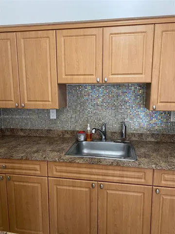 a kitchen with stainless steel appliances granite countertop white cabinets sink and dishwasher