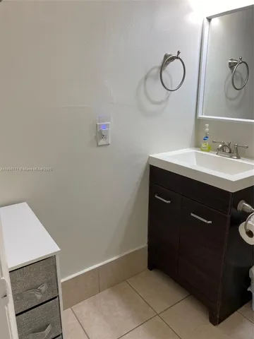 a room with a sink cabinets and utility