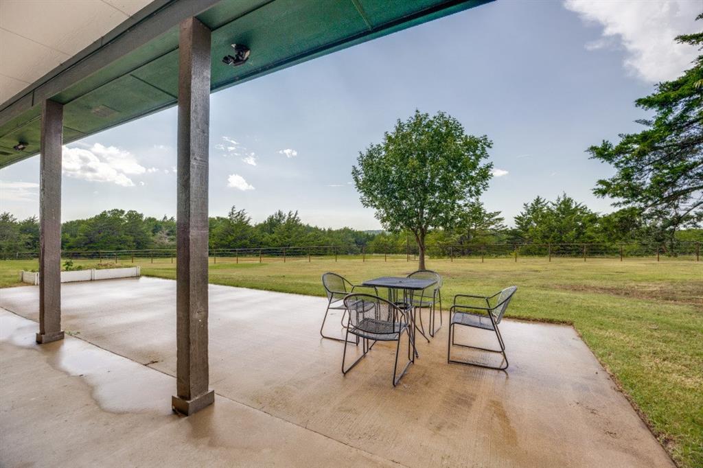 3244 Joe Davis Road Whitewright, TX 75491 - Photo 26 of 28 View of patio featuring outdoor dining space and view of scattered trees