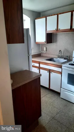 a kitchen with stainless steel appliances a sink cabinets and a window