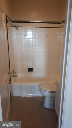 a bathroom with a shower and a toilet