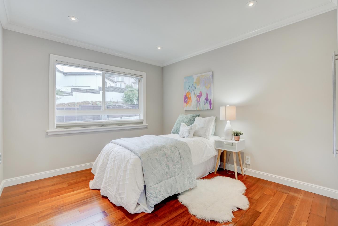 1112 Millbrae Avenue Millbrae, CA 94030 - Photo 29 of 100 a bedroom with a bed and wooden floor
