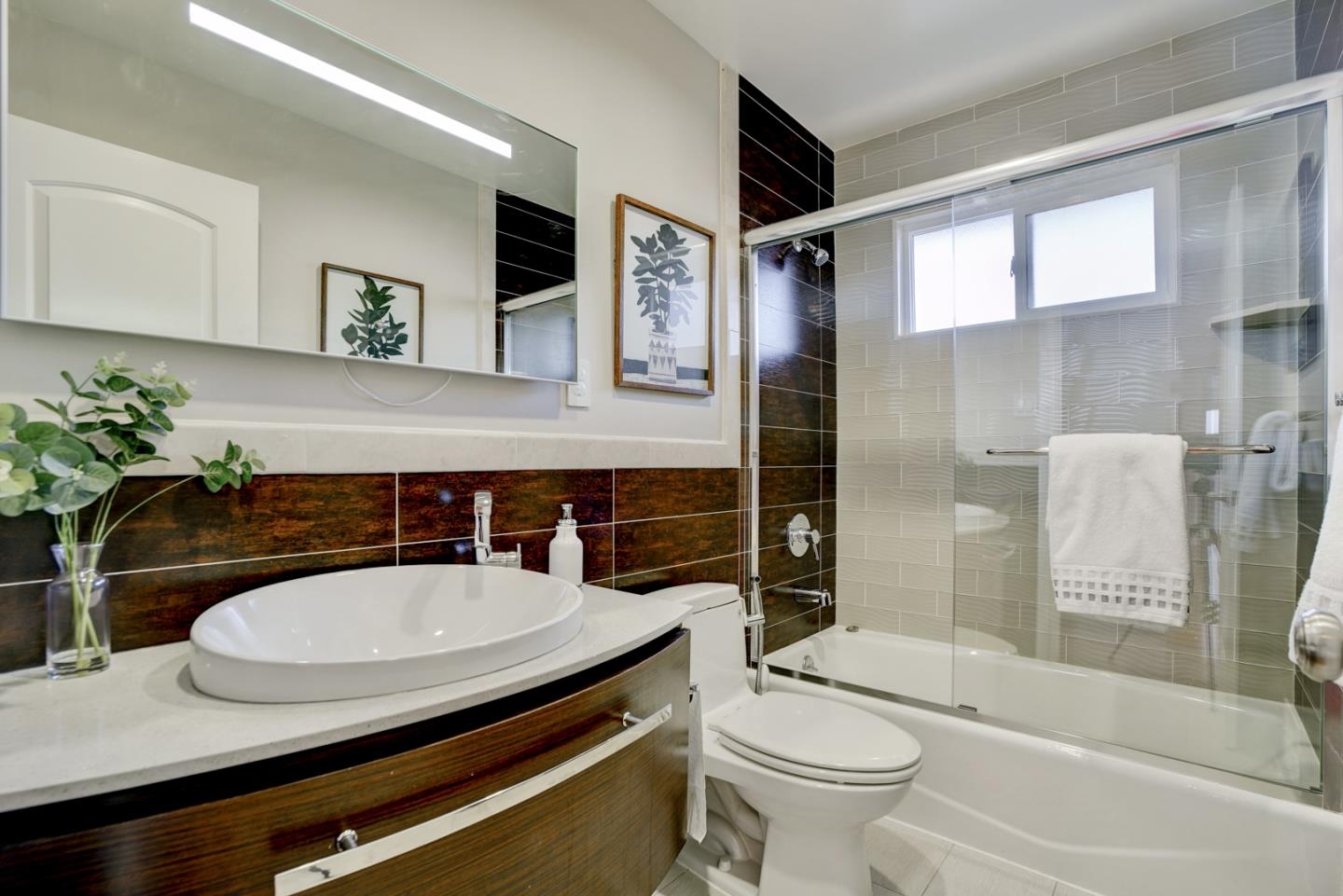 1112 Millbrae Avenue Millbrae, CA 94030 - Photo 35 of 100 a bathroom with a sink a toilet and shower