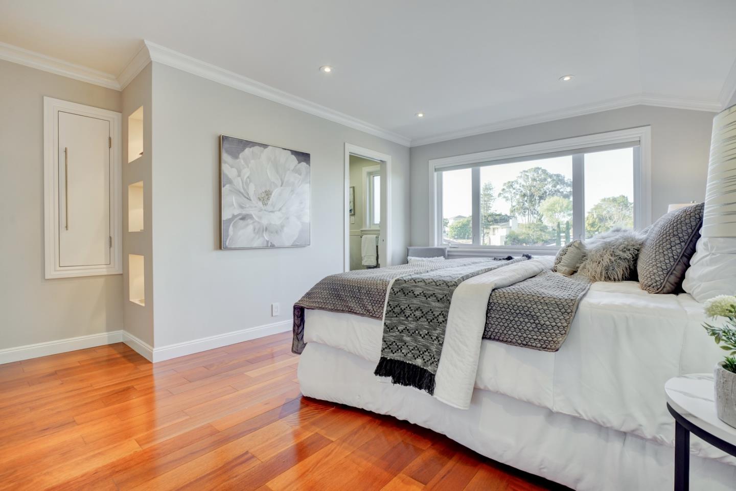 1112 Millbrae Avenue Millbrae, CA 94030 - Photo 38 of 100 a spacious bedroom with a large bed and a wooden floor