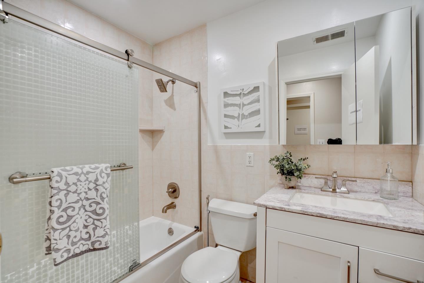 1112 Millbrae Avenue Millbrae, CA 94030 - Photo 73 of 100 a bathroom with a granite countertop sink toilet and shower