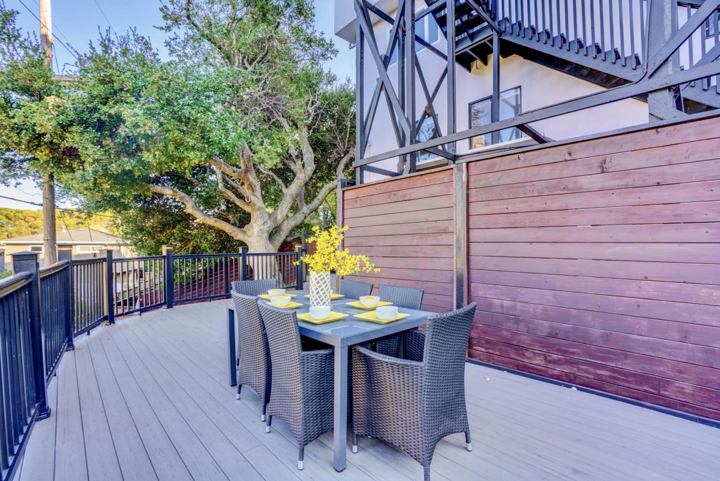 1112 Millbrae Avenue Millbrae, CA 94030 - Photo 94 of 100 a view of a patio with table and chairs with wooden floor and fence
