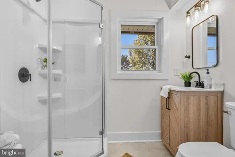 a bathroom with a shower and a toilet