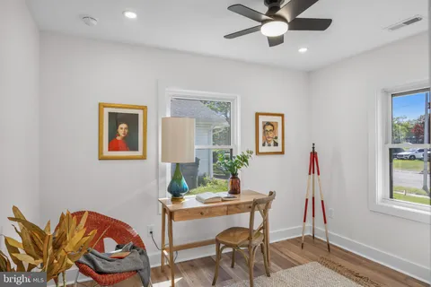 a view of a workspace with furniture and window